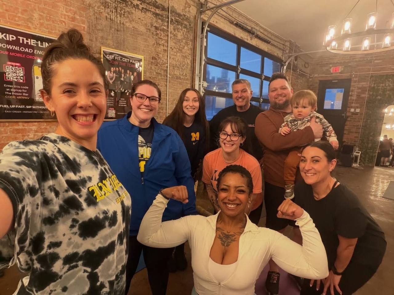A happy group selfie after a workout class inside The PWR Movement